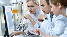 Scientists looking at a computer screen in a lab